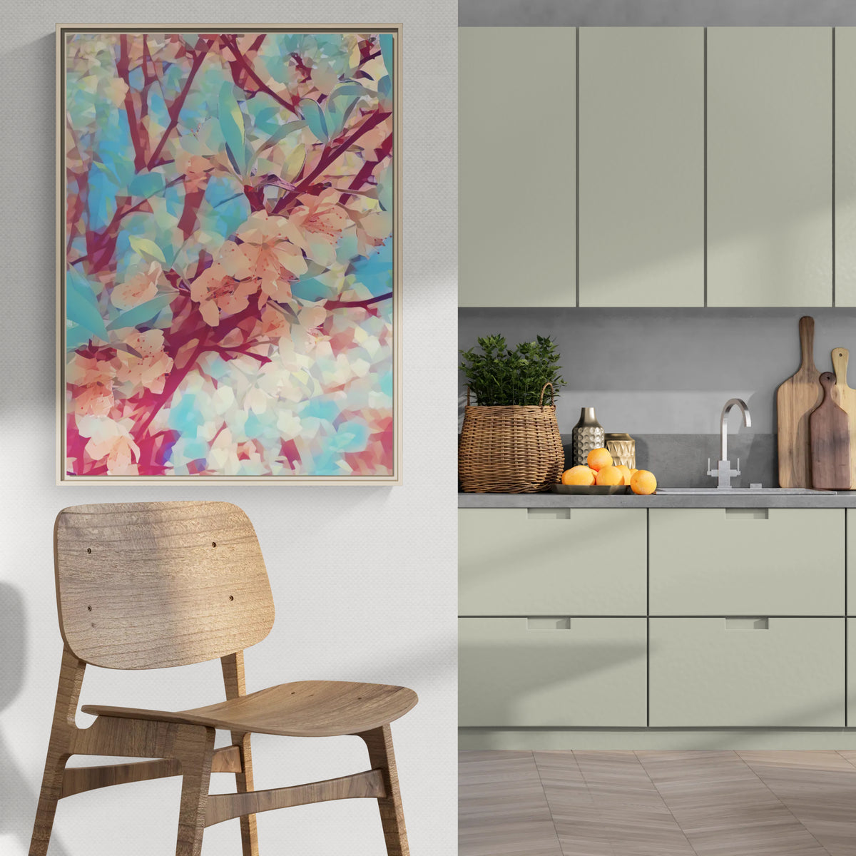Abstract floral wall art hanging in a modern kitchen with sage green cabinets and a wooden chair
