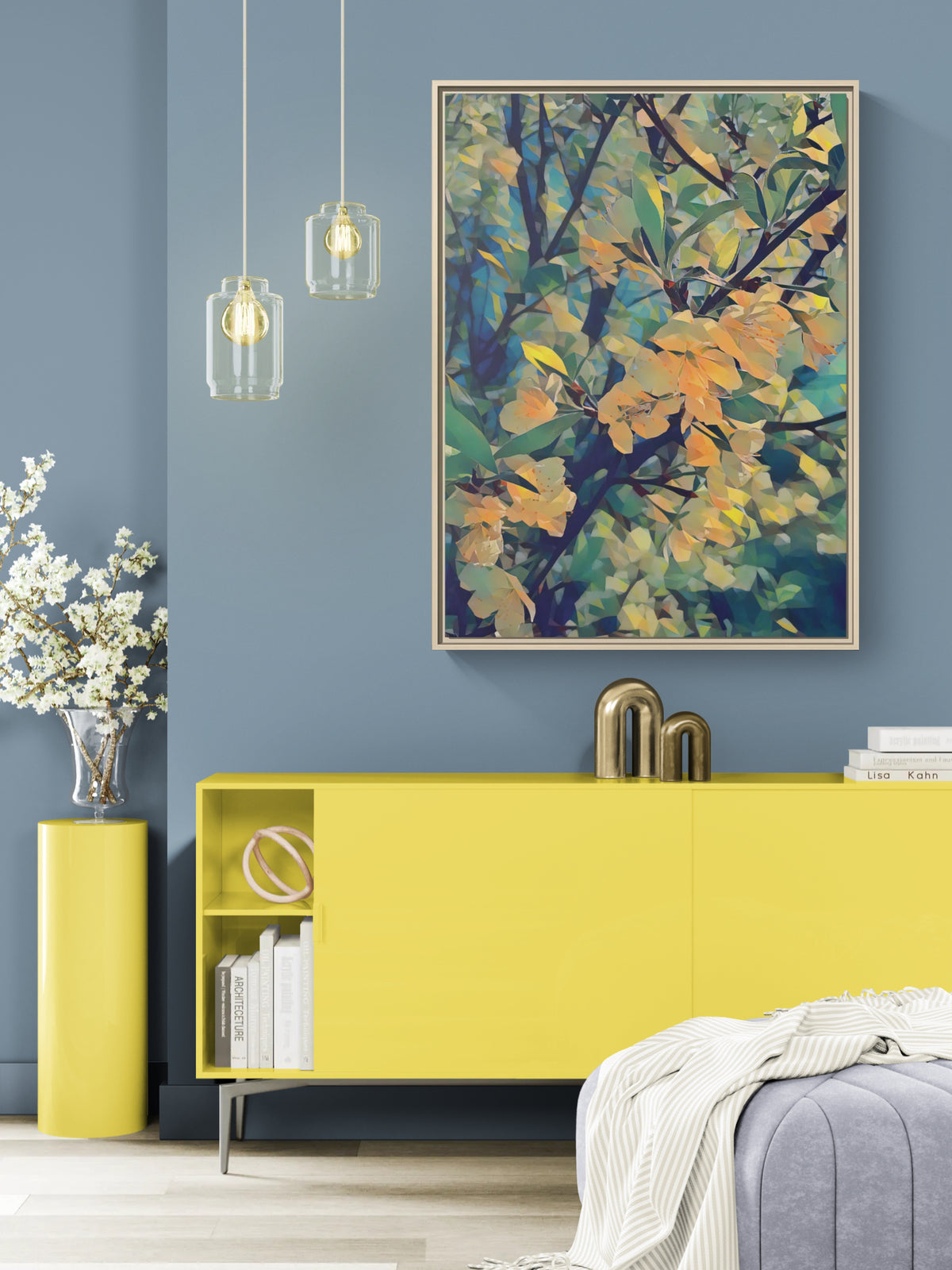 Abstract floral wall art in a wooden frame hanging above a yellow sideboard in a blue room