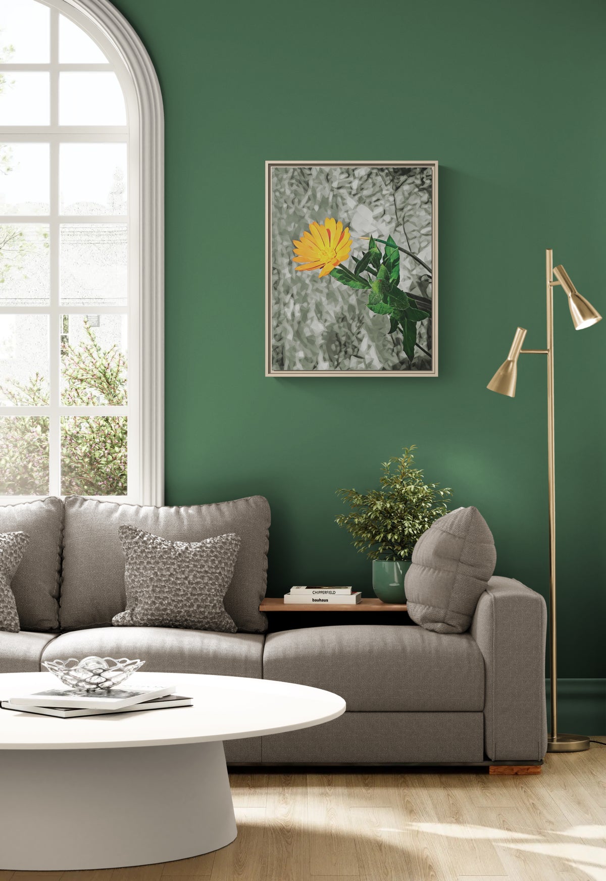 Framed floral wall art featuring a yellow flower on a grey textured background hanging above a grey sofa