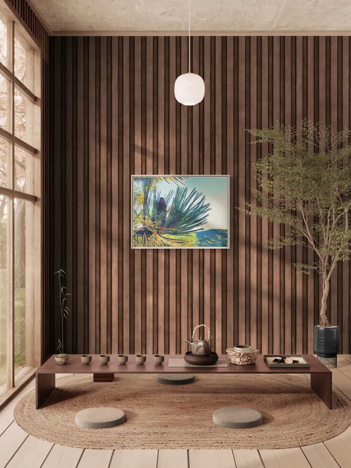 Low wooden tea table with cups and teapot in a room with wood slat walls and a framed pine tree print