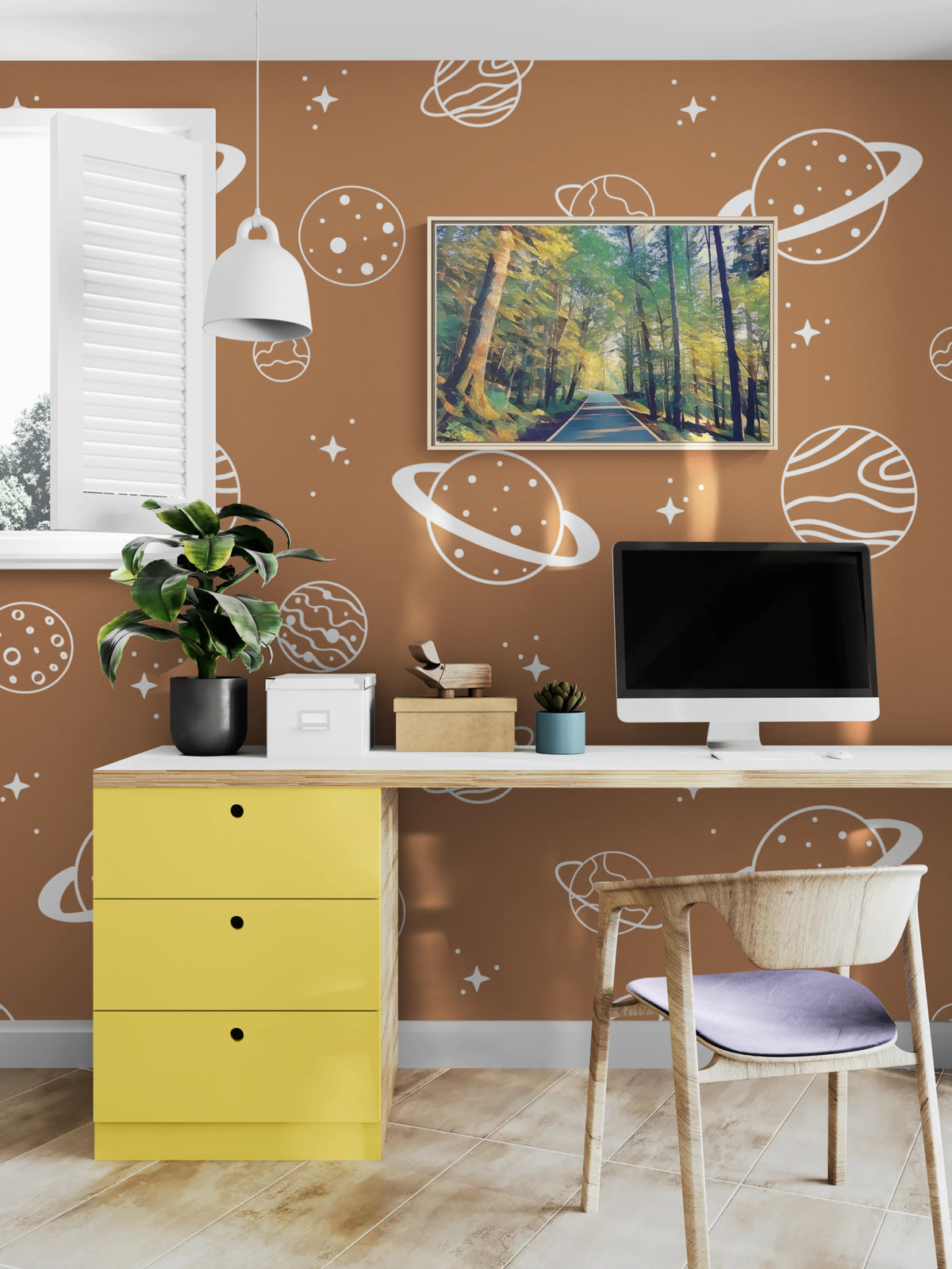 Home office desk with yellow drawers against brown wallpaper featuring white planet and star illustrations