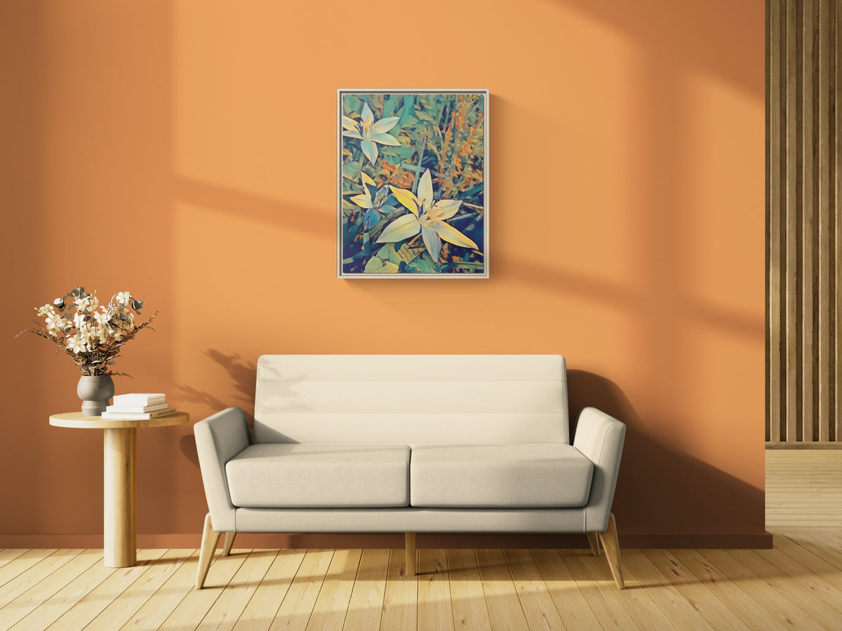 Framed floral art print hanging on an orange wall above a beige sofa and side table