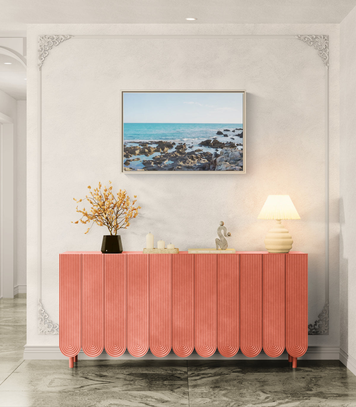 Coral fluted sideboard with coastal landscape wall art and table lamp