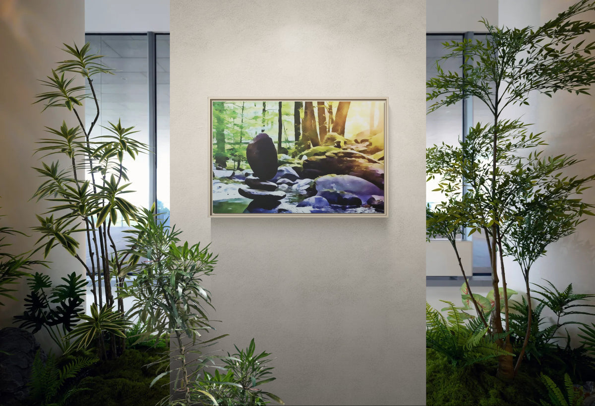 Framed wall art of a forest stream with stacked stones surrounded by indoor plants